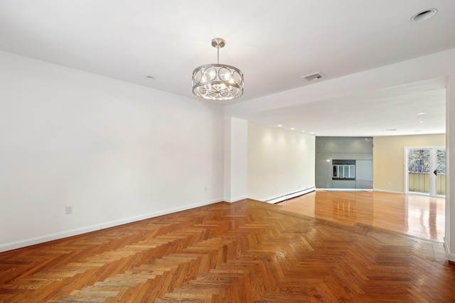 unfurnished living room with an inviting chandelier, baseboard heating, parquet floors, and a tiled fireplace