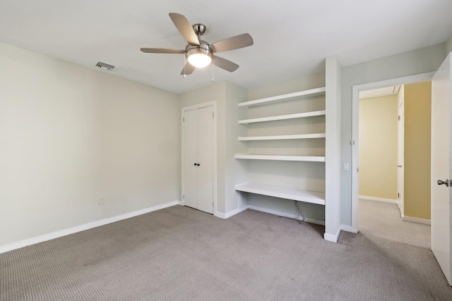 unfurnished bedroom featuring ceiling fan and light carpet