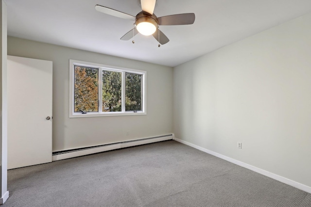 spare room featuring light colored carpet, ceiling fan, and a baseboard heating unit