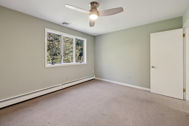 spare room with ceiling fan, light colored carpet, and a baseboard radiator