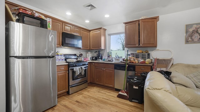 2413 Wilson Ave, Bronx, NY 10469 - kitchen featuring sink, light hardwood / wood-style flooring, and appliances with stainless steel finishes