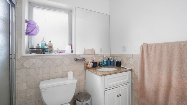 2413 Wilson Ave, Bronx, NY 10469 - bathroom featuring vanity, toilet, and tile walls