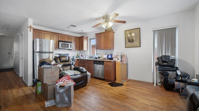 2413 Wilson Ave, Bronx, NY 10469 - kitchen with ceiling fan, light wood-type flooring, and appliances with stainless steel finishes