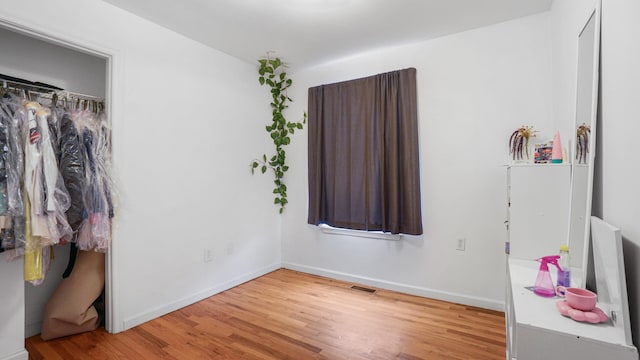 2413 Wilson Ave, Bronx, NY 10469 - bedroom with wood-type flooring and a closet