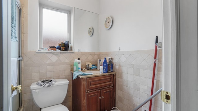 2413 Wilson Ave, Bronx, NY 10469 - bathroom with vanity, toilet, and tile walls