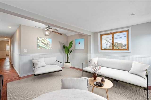 living room featuring wood-type flooring and ceiling fan