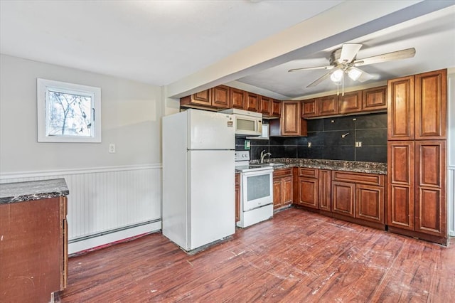 kitchen with baseboard heating, backsplash, dark hardwood / wood-style flooring, and white appliances