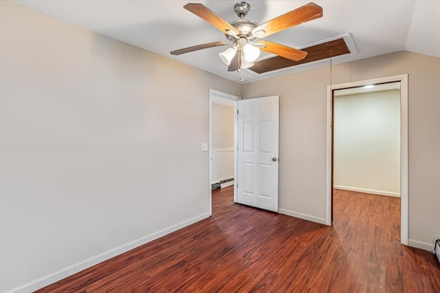 unfurnished bedroom with ceiling fan, a closet, dark wood-type flooring, and a baseboard heating unit