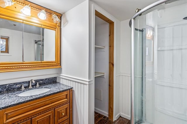 bathroom featuring vanity and an enclosed shower