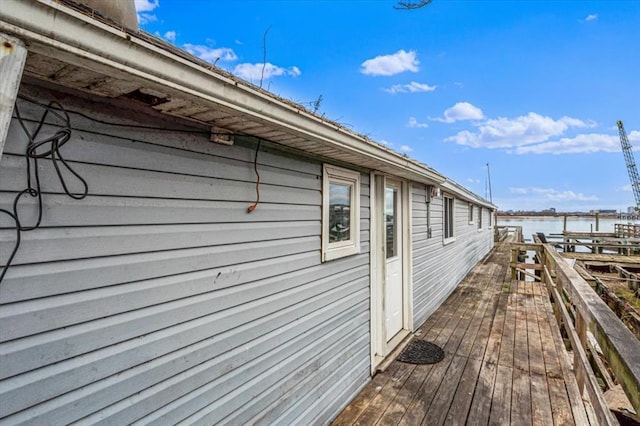 view of side of home featuring a deck with water view