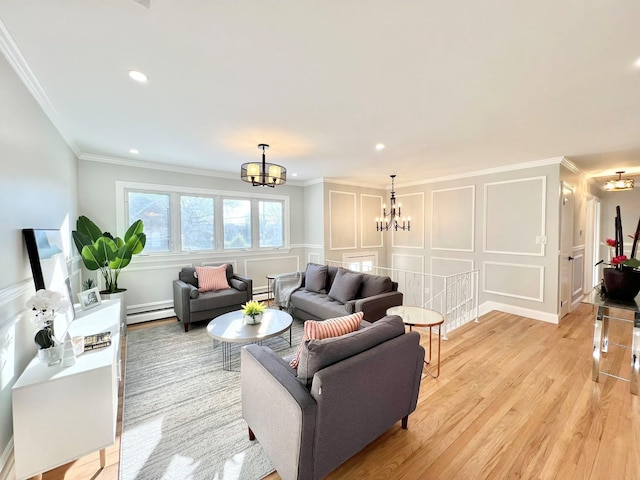 living room featuring a baseboard heating unit, light wood-type flooring, crown molding, and a notable chandelier