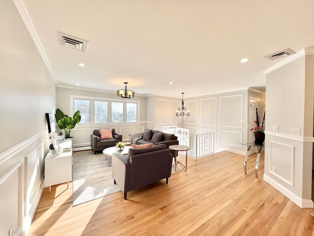 living room with light hardwood / wood-style floors, ornamental molding, a baseboard radiator, and an inviting chandelier