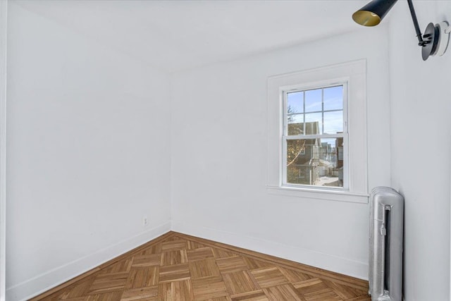 unfurnished room featuring radiator heating unit