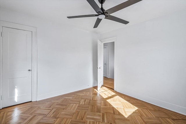 spare room with ceiling fan and light parquet floors