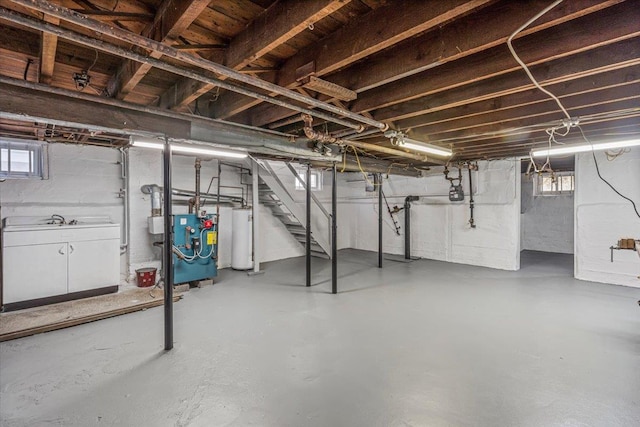 basement with plenty of natural light and water heater