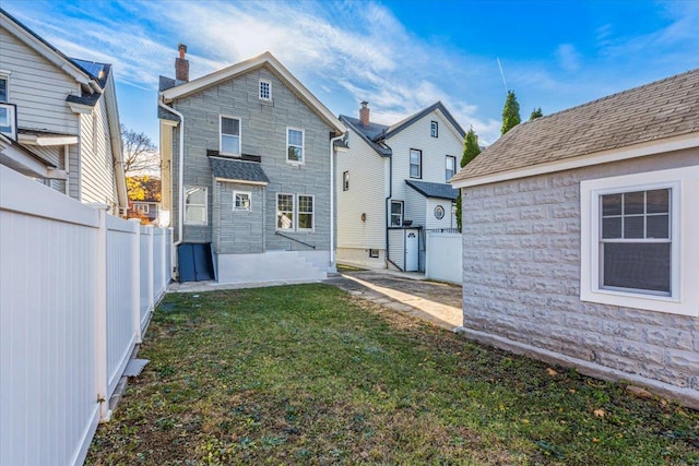 back of house with a yard