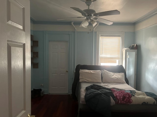 bedroom with dark wood-type flooring, ceiling fan, and crown molding