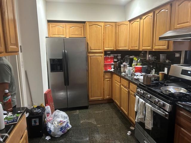 kitchen featuring stainless steel appliances and ventilation hood