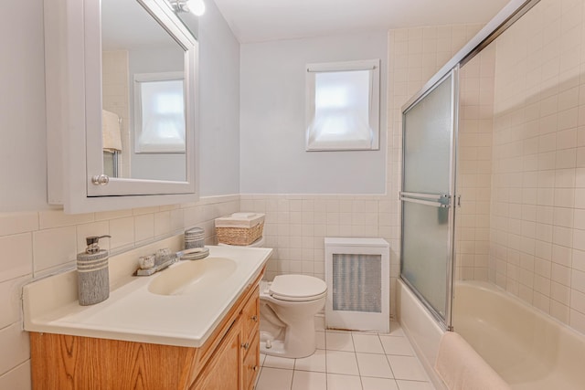 full bathroom featuring vanity, plenty of natural light, tile walls, and toilet