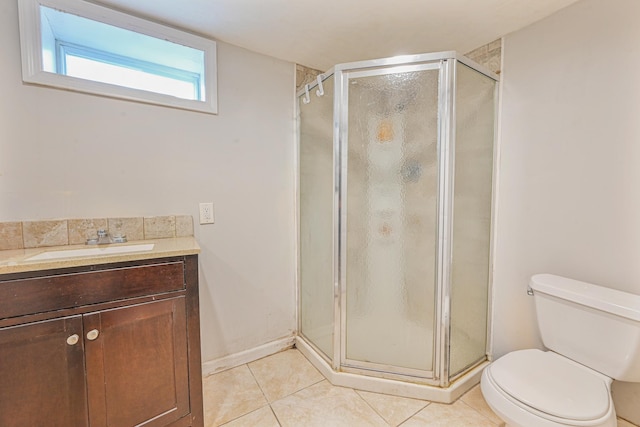 bathroom with vanity, tile patterned floors, a shower with door, and toilet