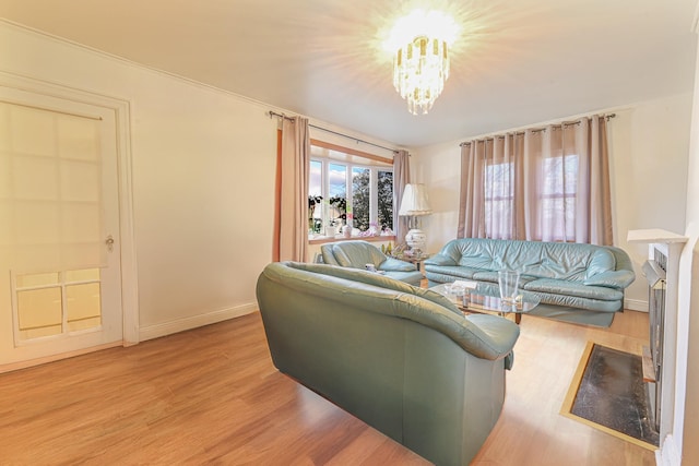 living room with a notable chandelier and light wood-type flooring