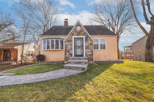 tudor home featuring a front yard