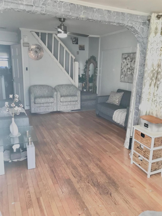 living room with ceiling fan, ornamental molding, and hardwood / wood-style flooring