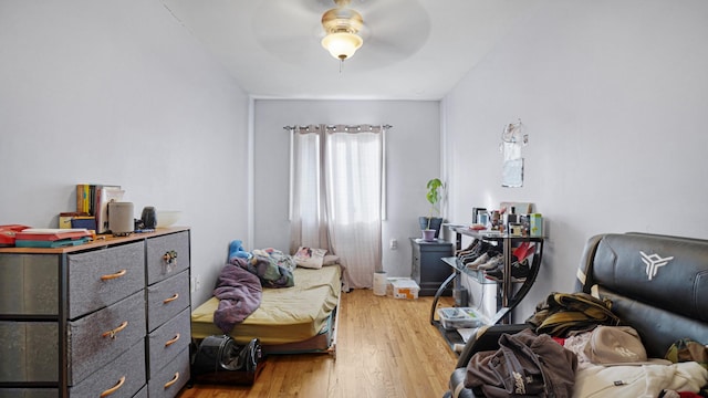 bedroom with light wood-type flooring and ceiling fan