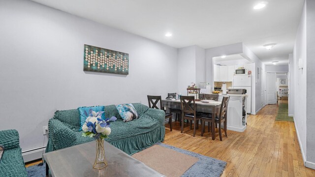 living room with light hardwood / wood-style floors and a baseboard radiator