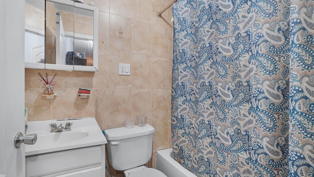 full bathroom with shower / bath combination with curtain, vanity, toilet, and tile walls