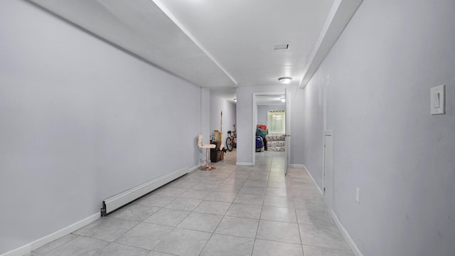 hallway featuring light tile patterned flooring and a baseboard radiator