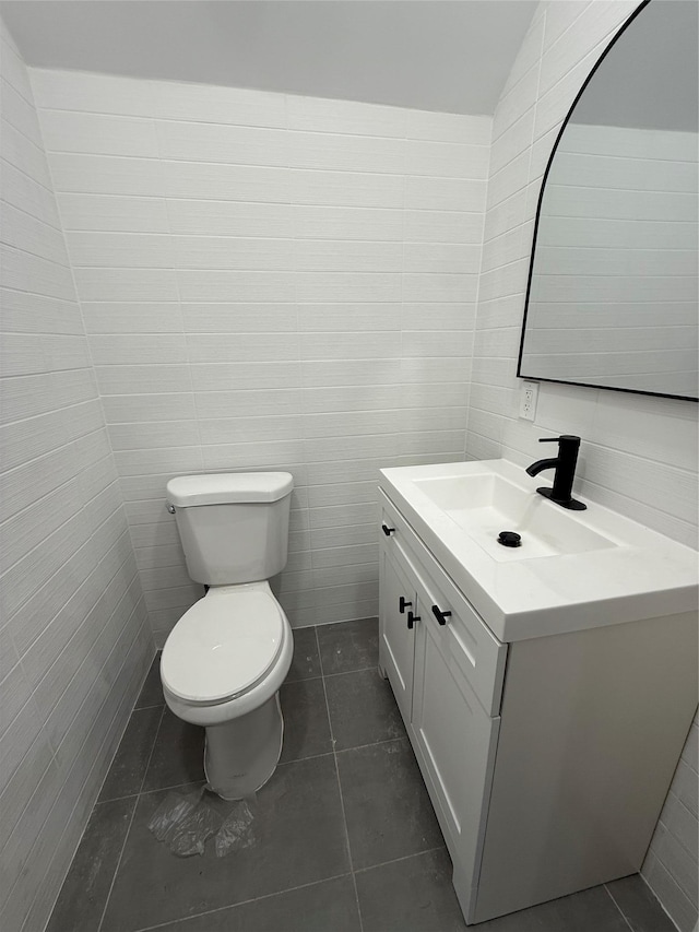 bathroom featuring vanity, tile patterned floors, and toilet