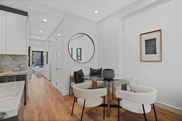 dining space featuring light wood-type flooring