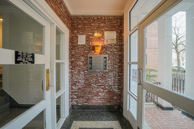 sunroom / solarium featuring french doors and a healthy amount of sunlight