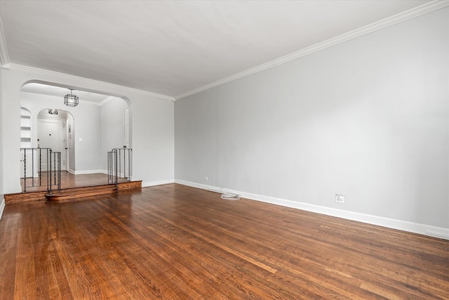 spare room featuring crown molding and hardwood / wood-style floors