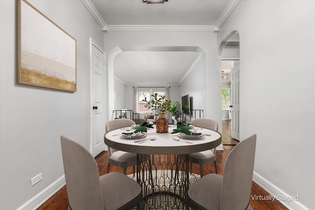 dining space with crown molding and dark wood-type flooring