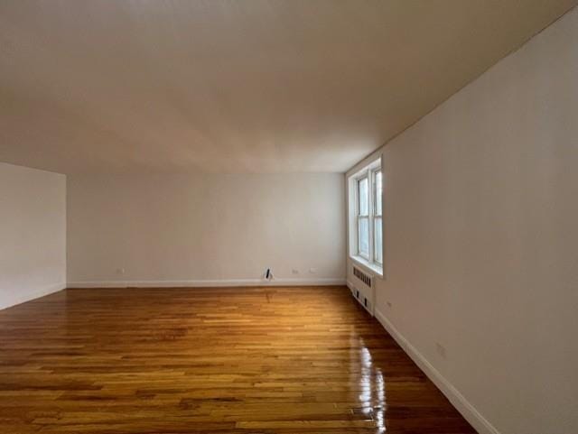 interior space with radiator and wood-type flooring