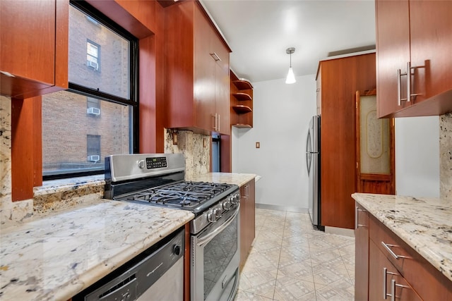 kitchen with decorative light fixtures, light stone countertops, stainless steel appliances, and a wealth of natural light