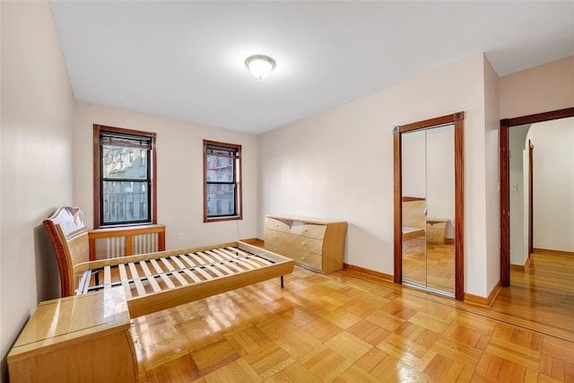 bedroom featuring a closet and light parquet floors