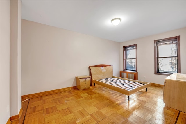 bedroom with light parquet floors