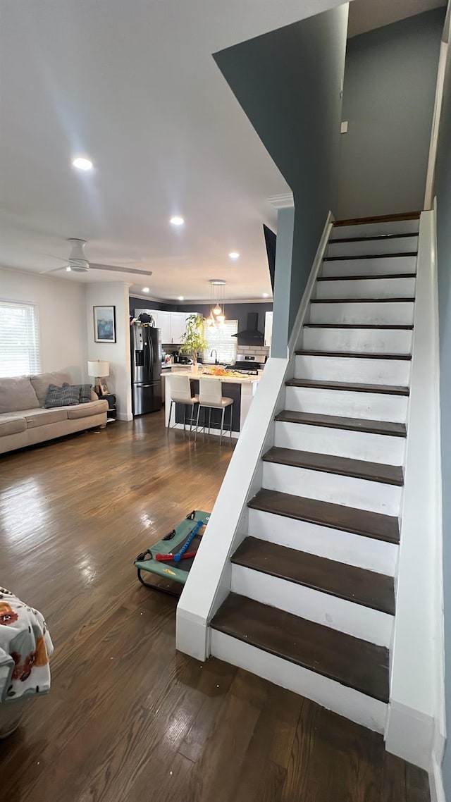 stairs with ceiling fan and hardwood / wood-style floors