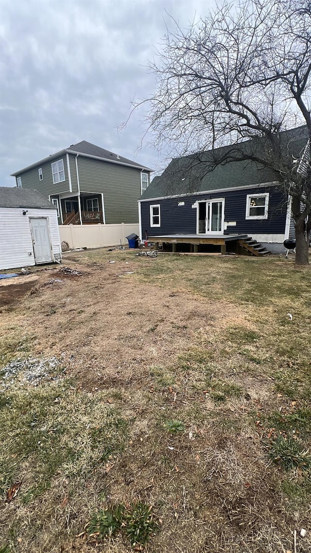 back of house featuring a lawn