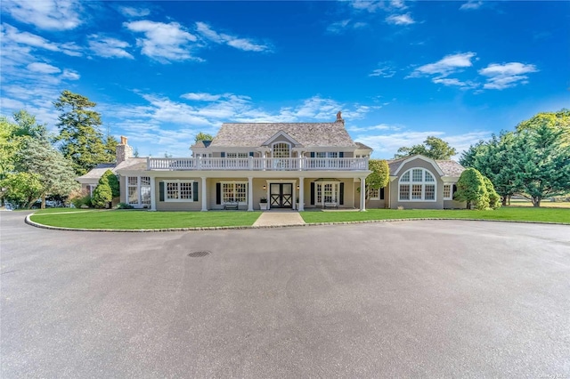 view of front of property with a front yard and french doors