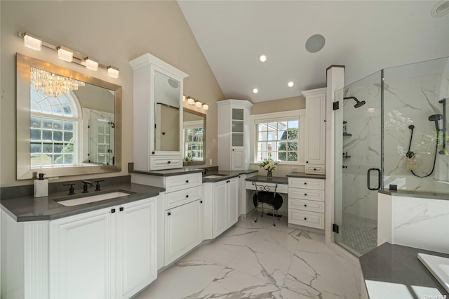 bathroom featuring walk in shower, vanity, vaulted ceiling, and an inviting chandelier