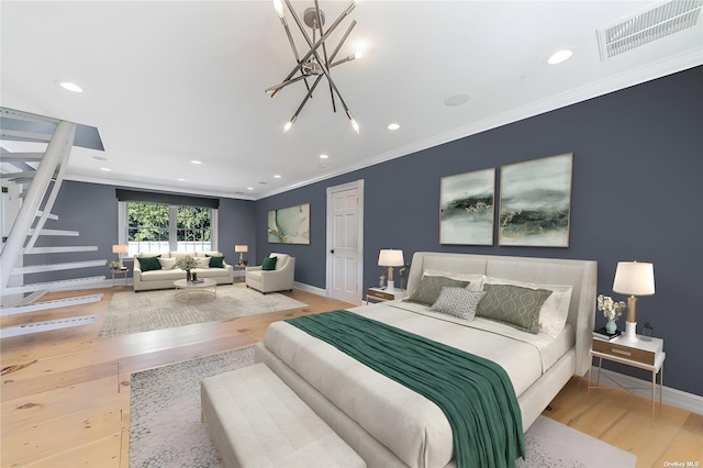 bedroom with ornamental molding, light hardwood / wood-style floors, and a chandelier