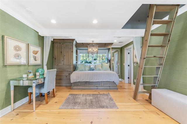 bedroom with crown molding, wood-type flooring, and an inviting chandelier