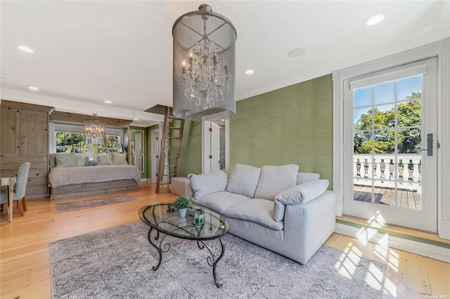 living room with light hardwood / wood-style floors and crown molding