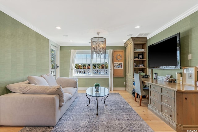 living room featuring light wood-type flooring, crown molding, and a chandelier