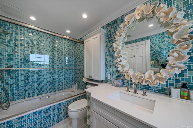 full bathroom with toilet, tiled shower / bath, tile walls, ornamental molding, and vanity