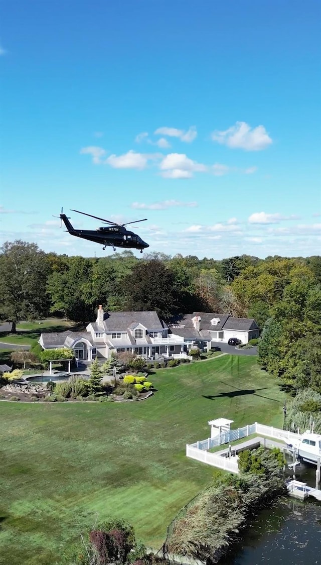 view of community featuring a water view and a lawn